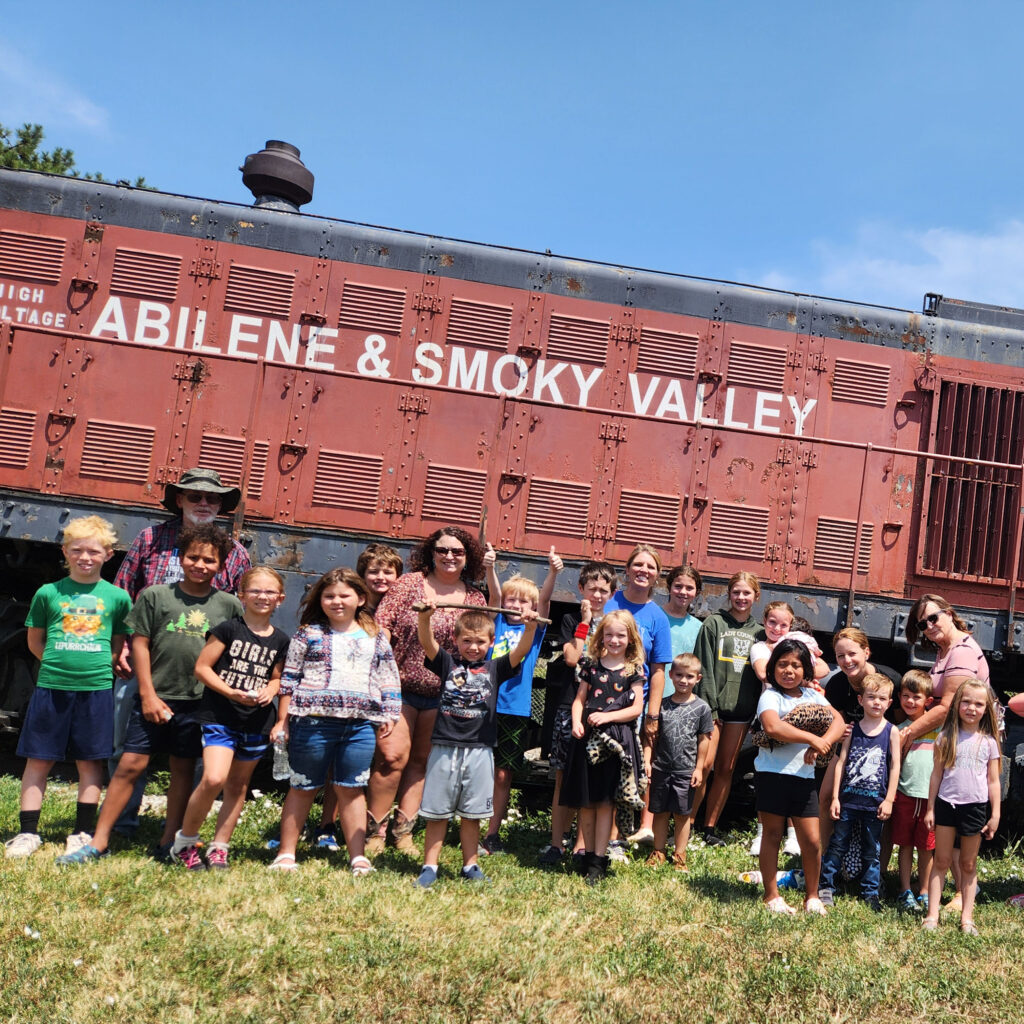 Children and families gathered for an outdoor Revolution Church event